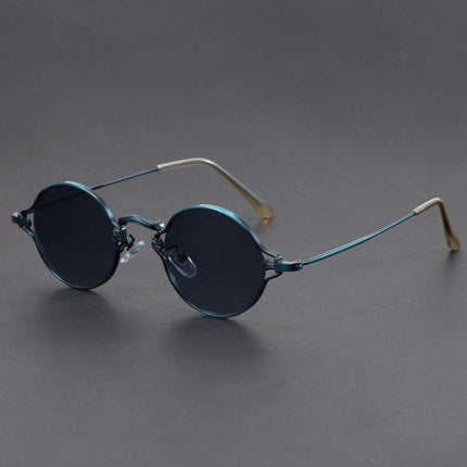 Anteojos de sol redondos Cobain de metal azul con diseño clásico y audaz, ideales para un estilo alternativo y despreocupado.
