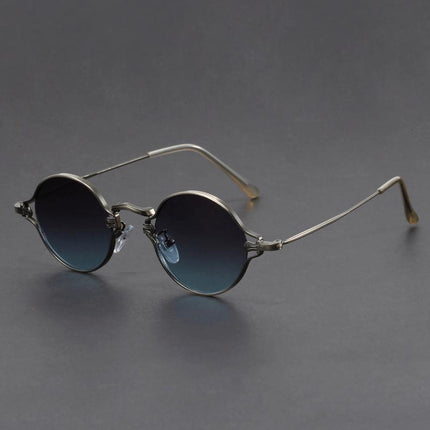 Anteojos de sol redondos Cobain, armazón metálico liviano, cristales con tinte azul, estilo alternativo unisex.