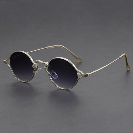Anteojos de sol redondos Cobain, armazón metálico dorado, lentes oscuras. Estilo clásico alternativo para jóvenes audaces.