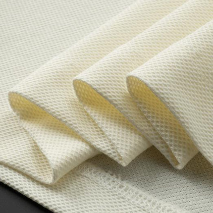 Tela de punto suave color crema con textura de panal, adecuada para confección de ropa elegante y cómoda.