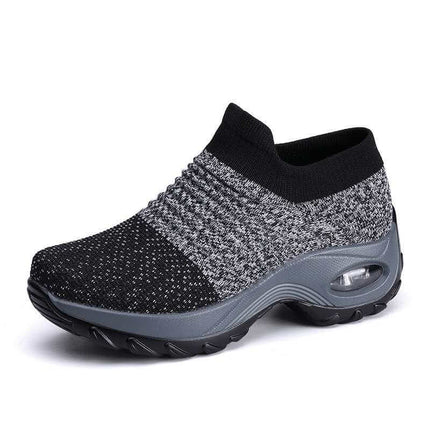 Zapatillas deportivas transpirables negras y grises para adultos, diseño con airbag y tela flexible, ideales para caminar.