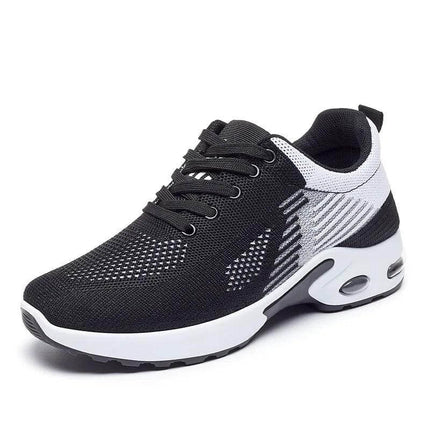 Zapatillas de running transpirables negras y blancas para adultos, diseño ergonómico y suela anti-impacto.