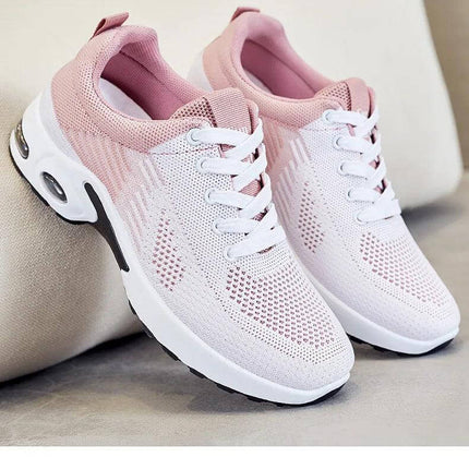 Zapatillas transpirables de mujer, color blanco y rosa, con suela anti-impacto y diseño ergonómico.