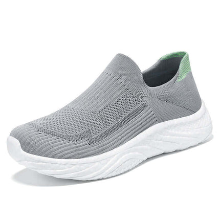 Zapato casual de mujer, tejido transpirable gris con suela blanca, ideal para comodidad y estilo informal.
