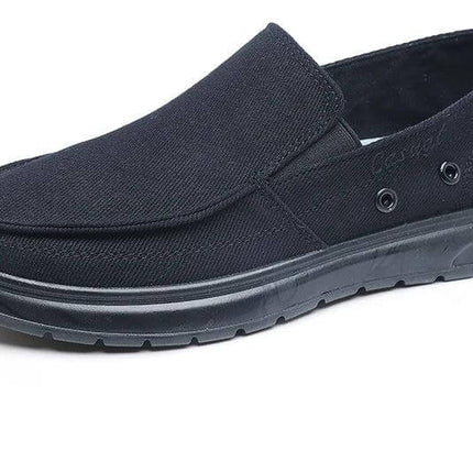 Zapatos de lona negros casuales para hombres, ideales para caminar, con diseño slip-on y suela de goma.