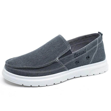 Zapato de lona gris para caminatas casuales para hombres con suela blanca, ideal para uso diario y estilo informal.